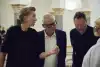 two women and two men talking about an artwork that is not seen in the photo